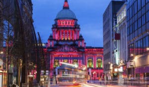 The Best Pub Guide - Belfast City Hall shines bright in pink and purple after dark, surrounded by bustling city buildings and the colourful blur of passing traffic. All this is just a stone’s throw from some of the city’s favourite pubs featured in our Belfast pub guide—why not pop by and see it for yourself between stops?. | Pub Directory UK